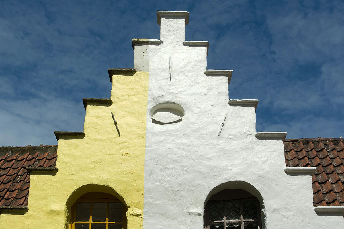 Colorful historic house façade with yellow and white paint